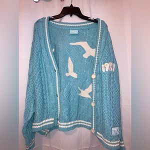 Brand new, never worn, Taylor Swift 1989 cardigan. Size is M/L.